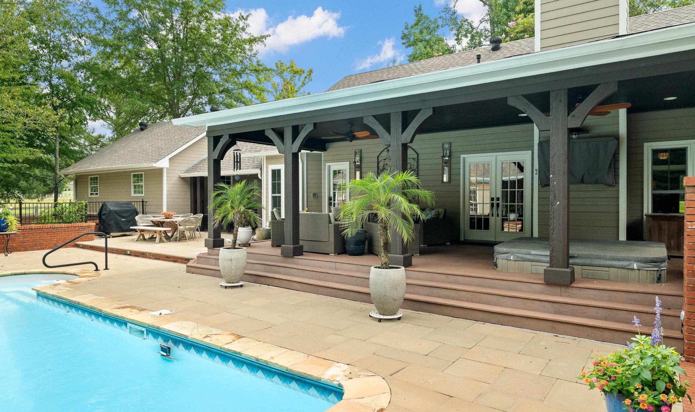 Resort backyard with pool, pavilion, and hot tub