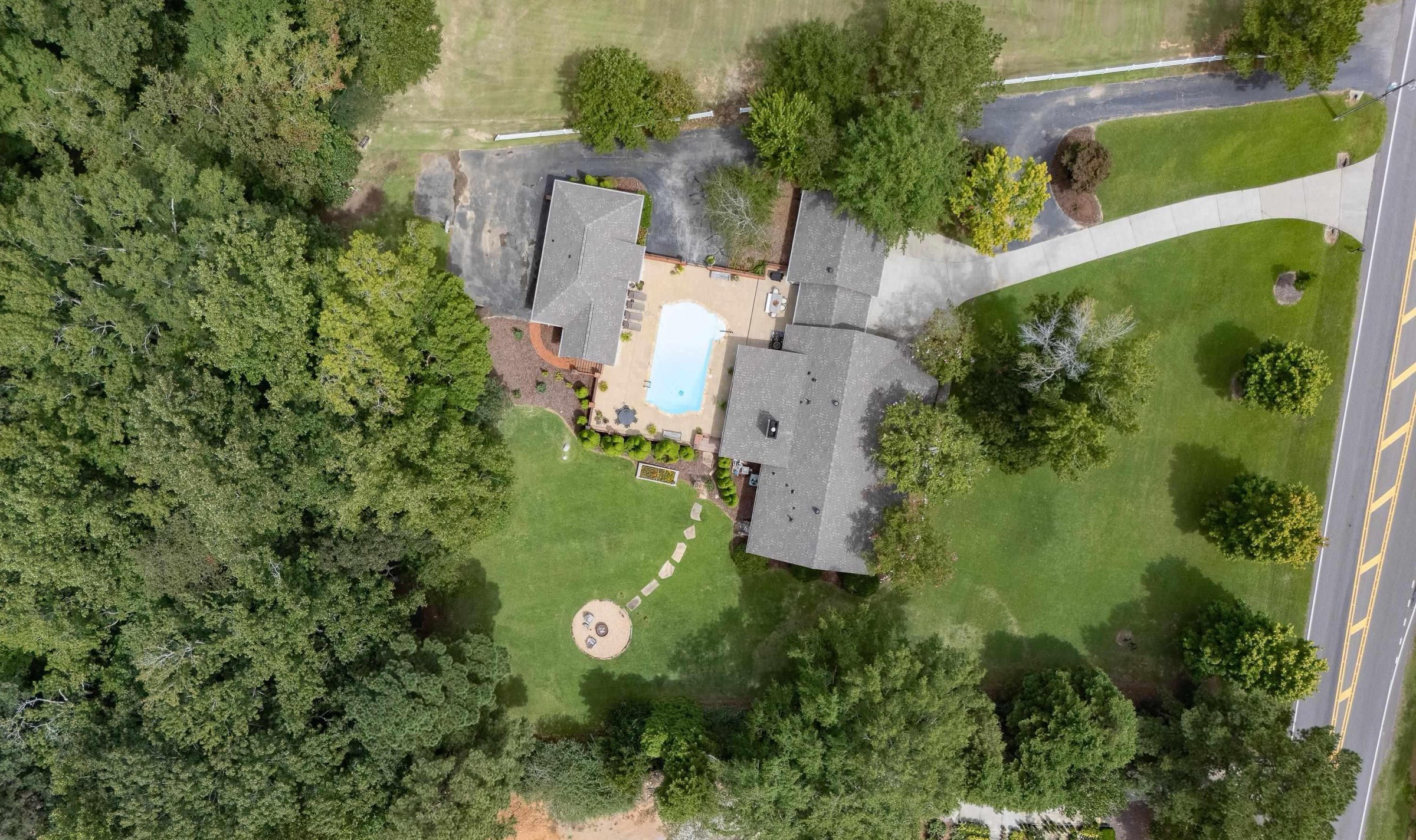 Aerial of the two-home compound: main house, carriage house, and pool on two acres